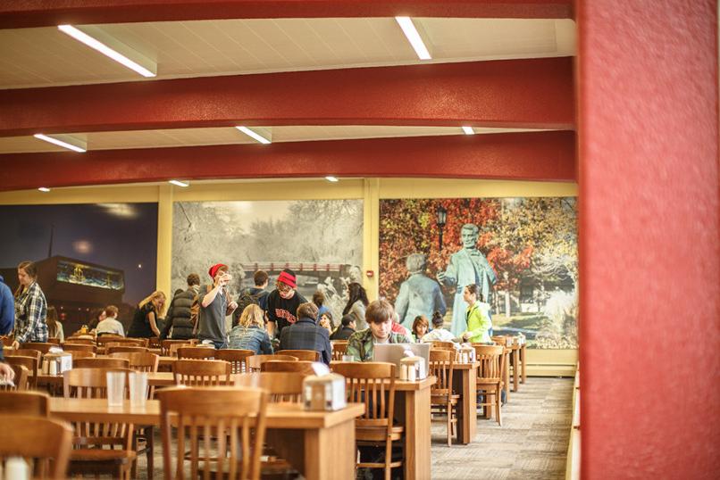 Students sit down to eat a meal at The Caf.